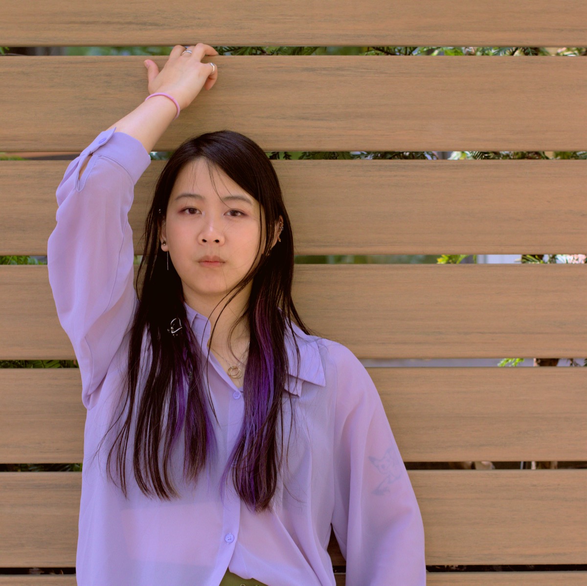 Honey posing in front of a fence